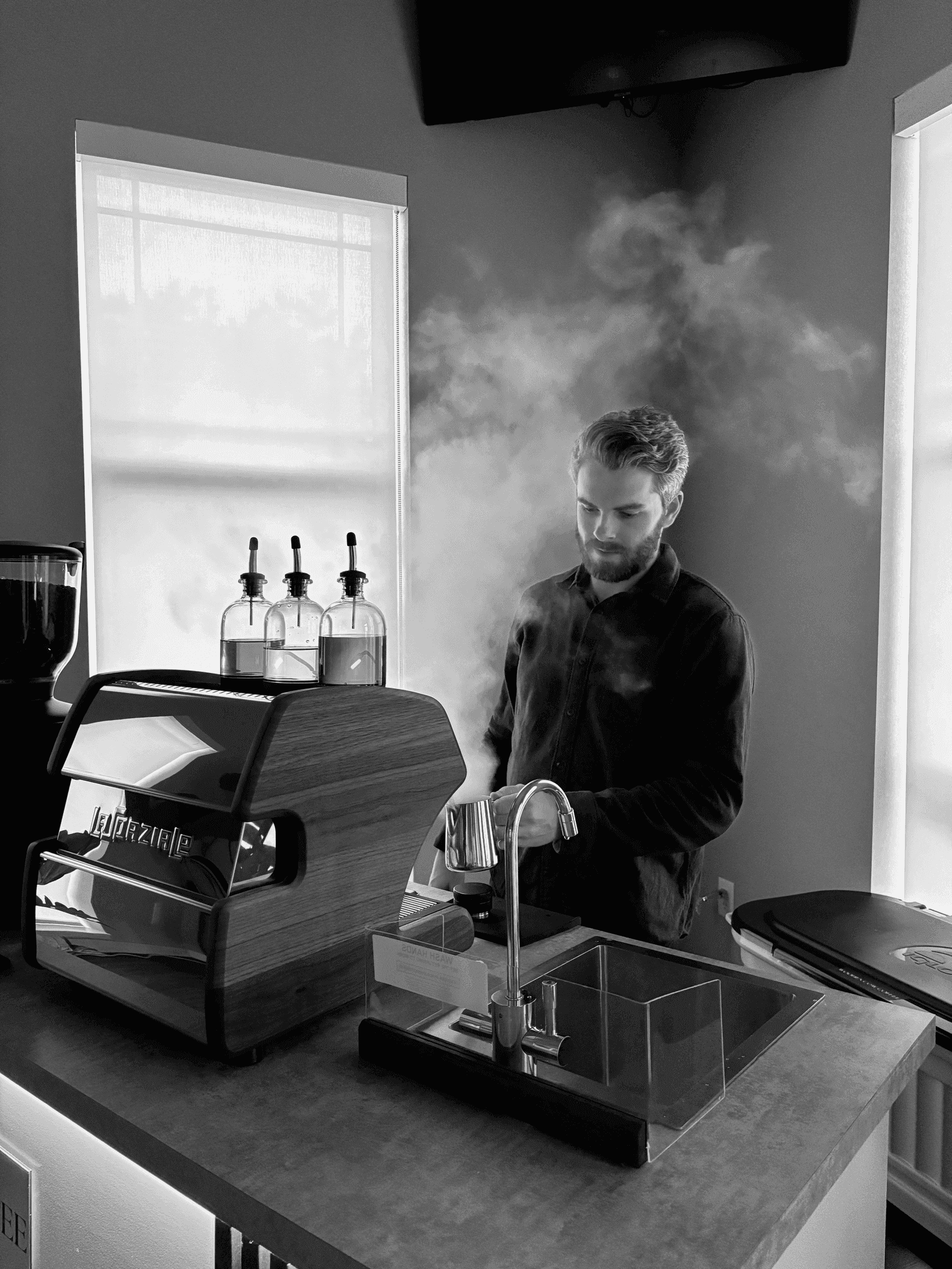 Spencer steaming milk behind the espresso bar